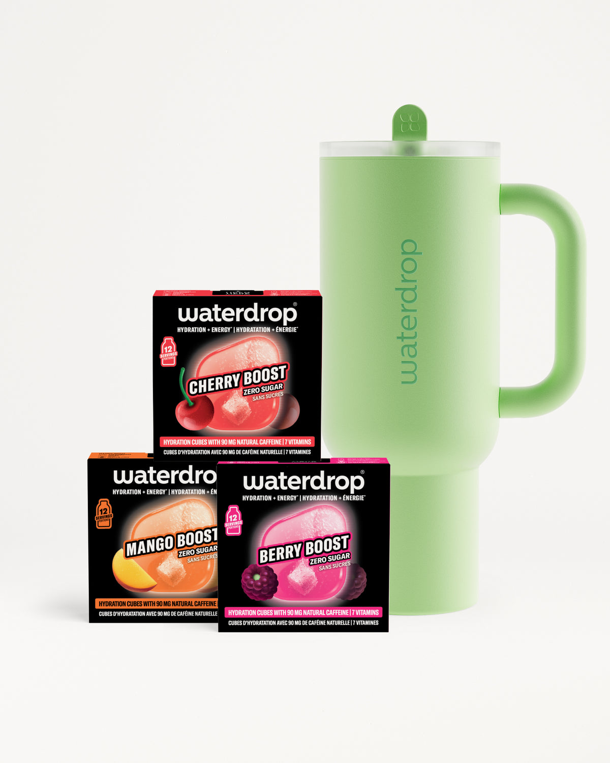 Tres cajas de sabor con tonos naranja, rosa y morado junto a una taza aislante verde claro con asa.
