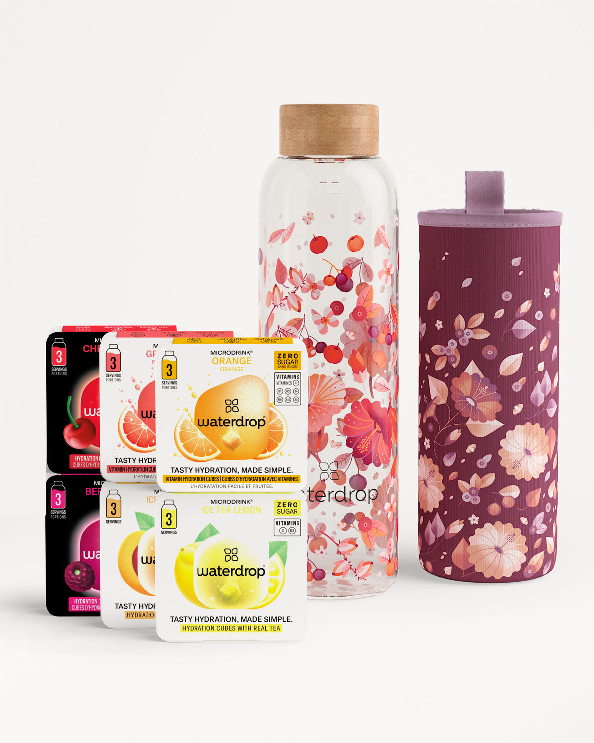 Cajas variadas de tabletas de sabor Waterdrop junto a una botella de vidrio con diseño floral y una funda floral a juego.