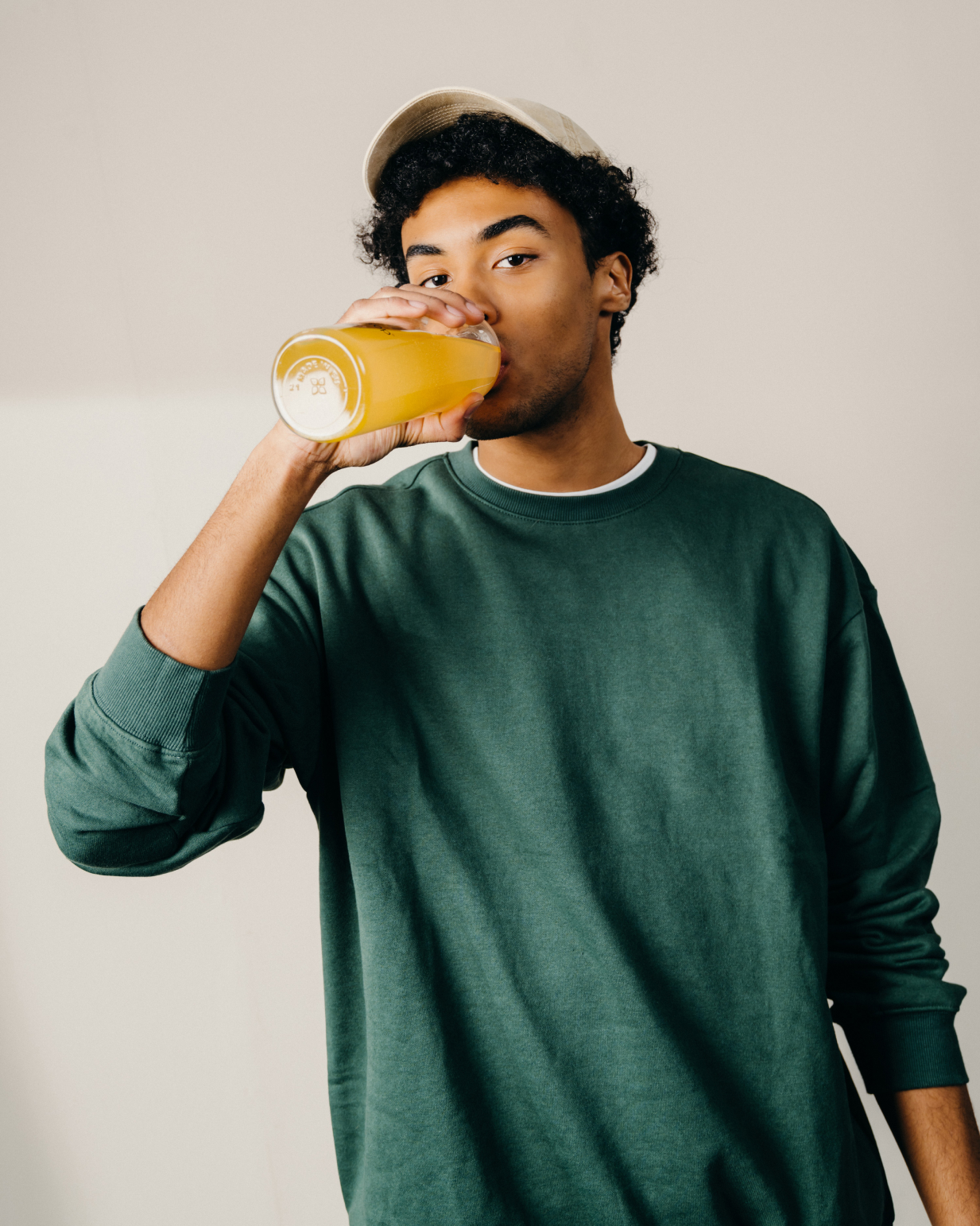 Man drinking from a glass, promoting waterdrop® Microdrink Taster Pack with six flavors for a refreshing water experience using natural fruit and plant extracts.