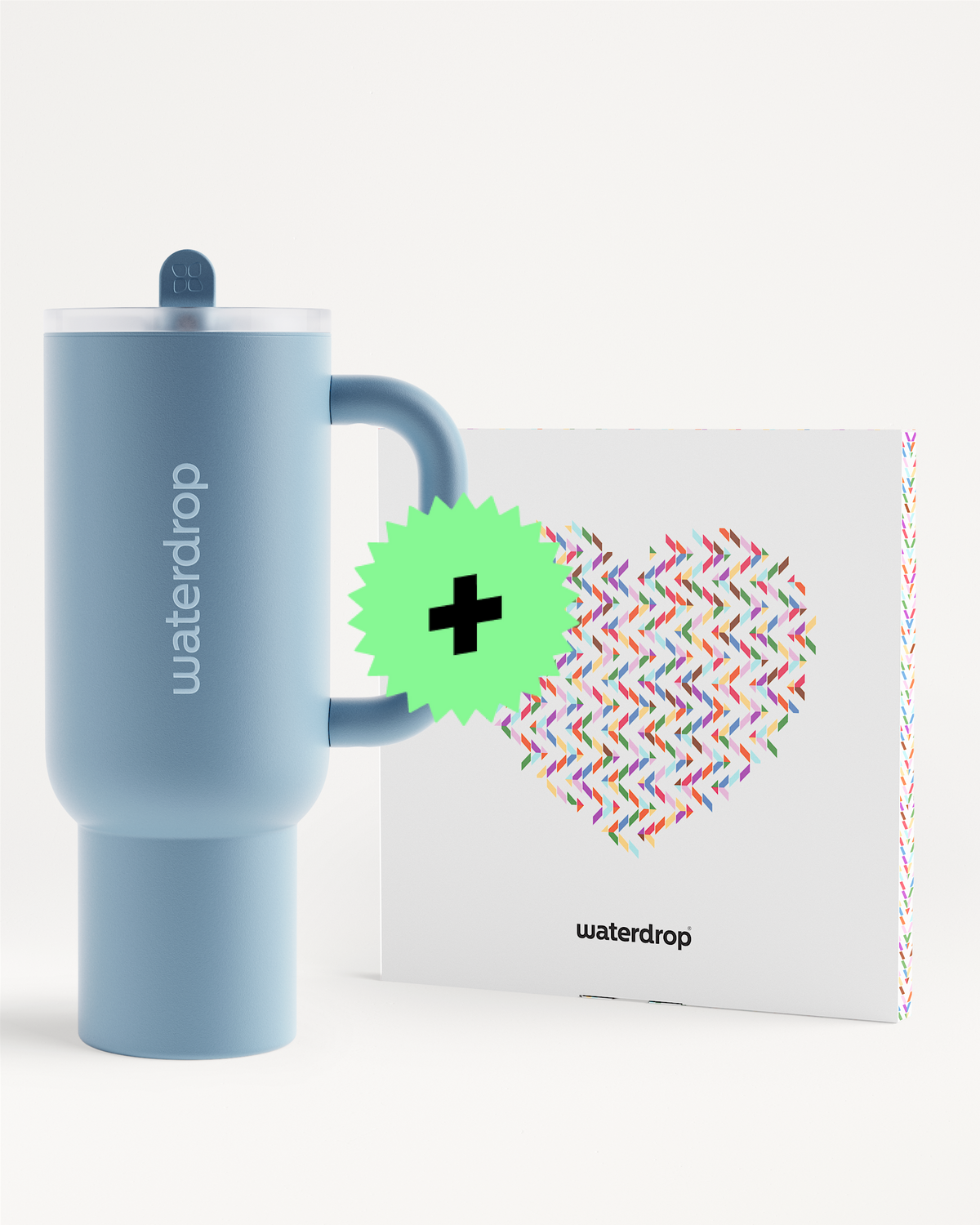 Vaso térmico azul de doble pared con tapa junto a una caja blanca con un patrón de zigzag multicolor.