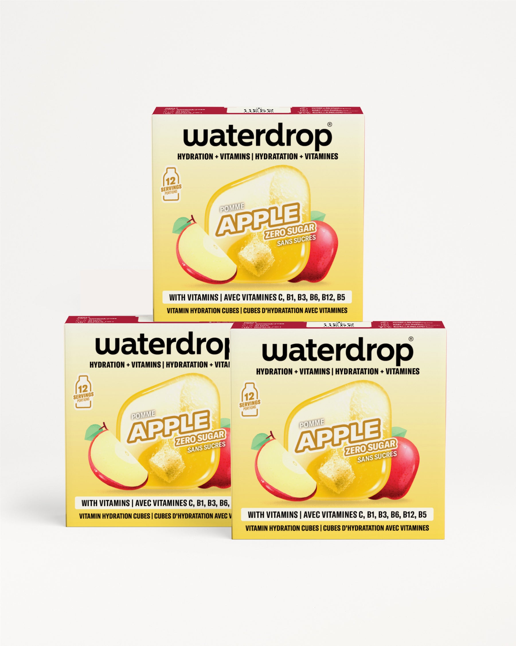 Tres cajas de Waterdrop sabor manzana para hidratación con vitaminas apiladas en forma de pirámide.