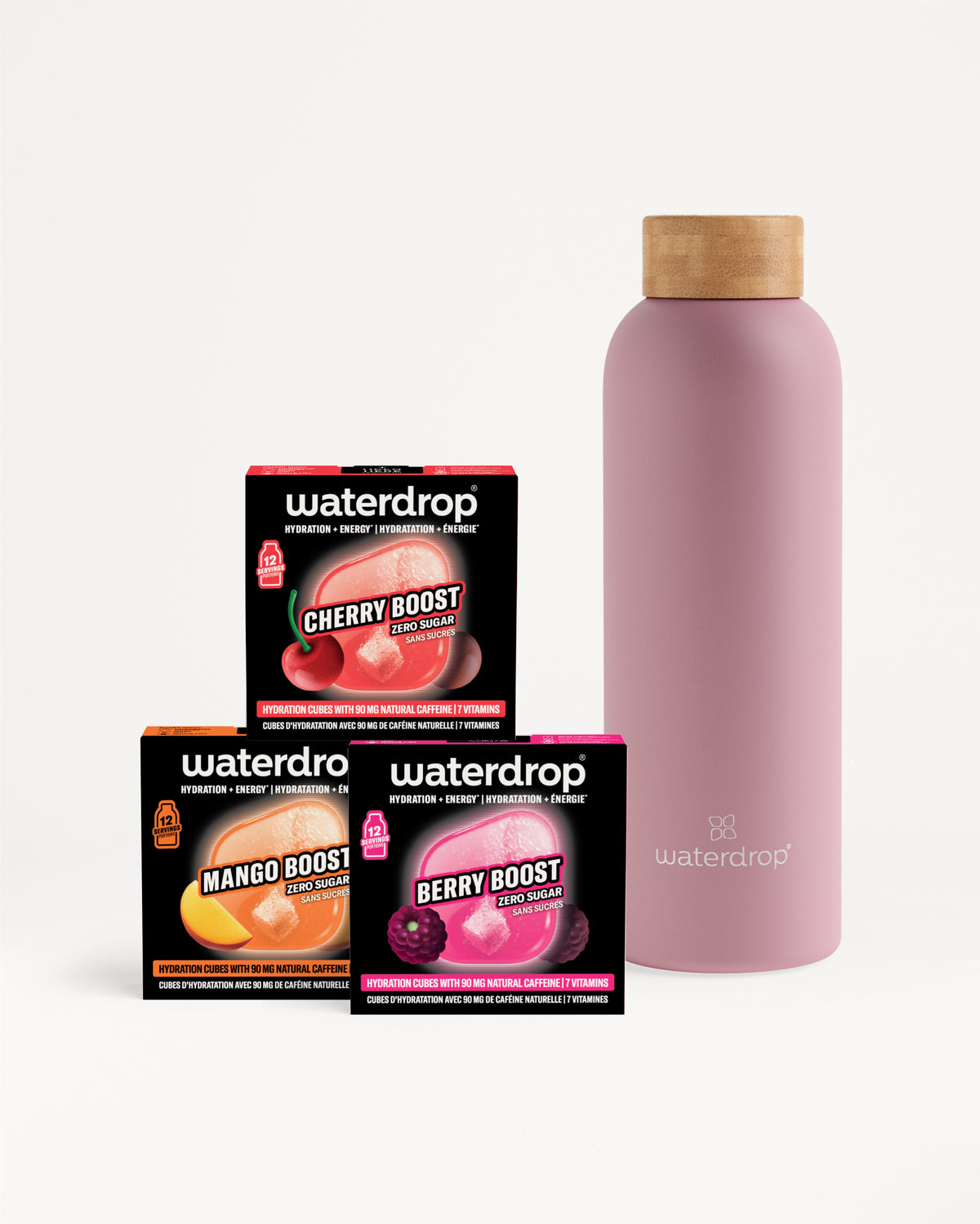 Tres cajas de saborizantes y una botella reutilizable rosa con tapa de madera.