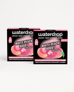 Dos cajas negras de Waterdrop para hidratación con acentos rosados sobre fondo blanco.